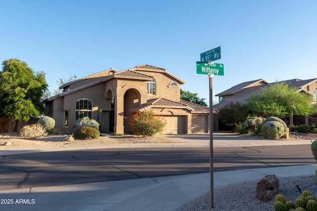 9571 E Nittany Dr, Scottsdale, AZ 85255 - mediterranean / spanish-style house featuring concrete driveway, stucco siding, a tile roof, and an attached garage