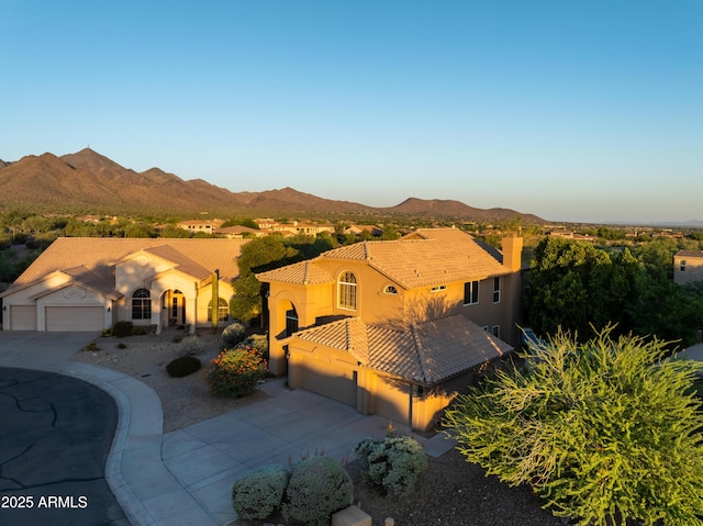 9571 E Nittany Dr, Scottsdale, AZ 85255 - mediterranean / spanish-style home featuring driveway, a garage, a mountain view, and stucco siding