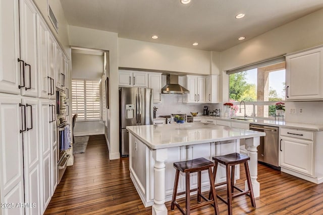 9571 E Nittany Dr, Scottsdale, AZ 85255 - kitchen with appliances with stainless steel finishes, wall chimney range hood, white cabinetry, and recessed lighting
