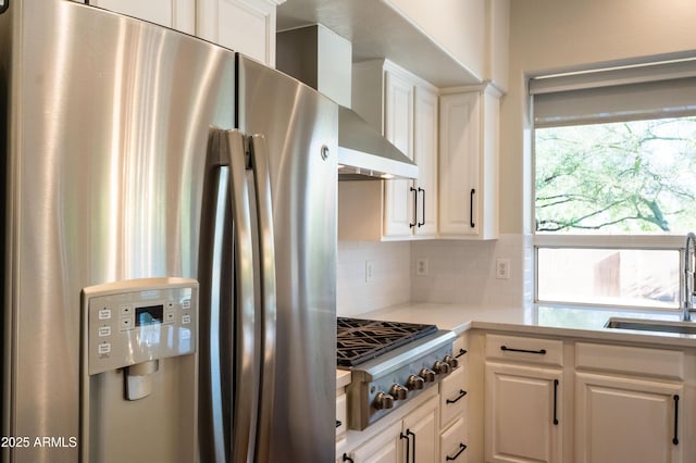 9571 E Nittany Dr, Scottsdale, AZ 85255 - kitchen featuring stainless steel appliances, backsplash, white cabinets, light countertops, and wall chimney exhaust hood