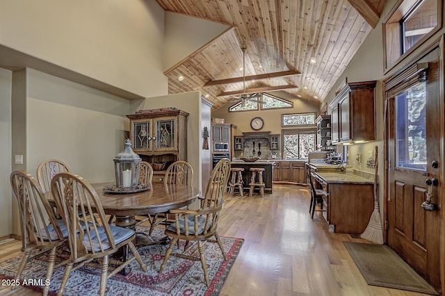 dining area with wooden ceiling, high vaulted ceiling, light wood-type flooring, and ceiling fan