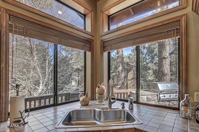 kitchen featuring tile patterned floors and a sink