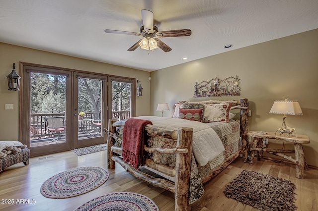 bedroom with access to exterior, visible vents, light wood finished floors, and ceiling fan