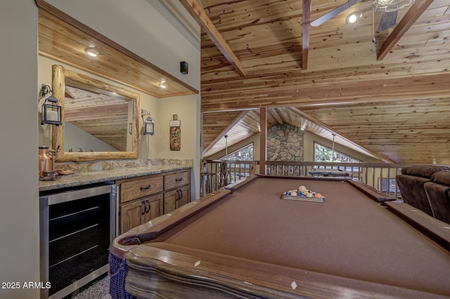 recreation room with vaulted ceiling with beams, wine cooler, a dry bar, wooden ceiling, and a ceiling fan