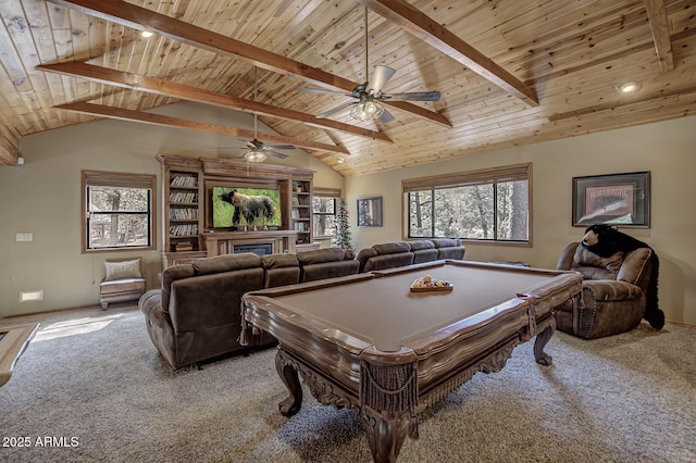 game room featuring ceiling fan, beam ceiling, carpet, and wooden ceiling