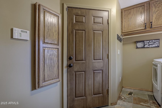 laundry area with washer and dryer, baseboards, laundry area, and stone finish floor