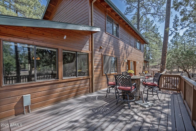 wooden terrace with outdoor dining space