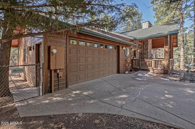 garage featuring a porch and driveway