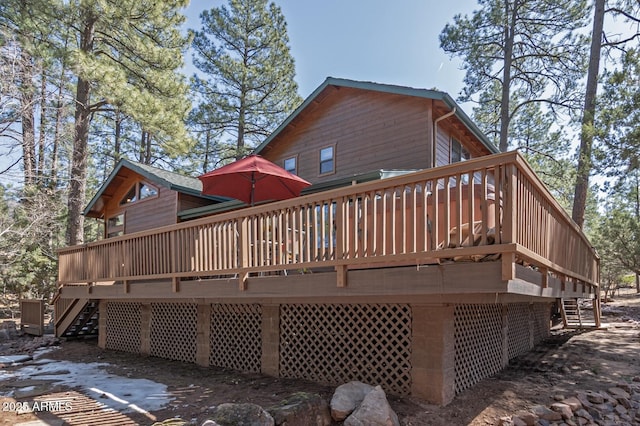 back of property featuring a wooden deck