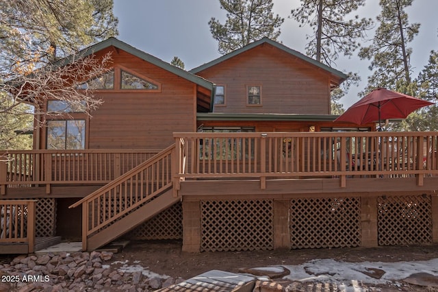 rear view of property featuring a deck