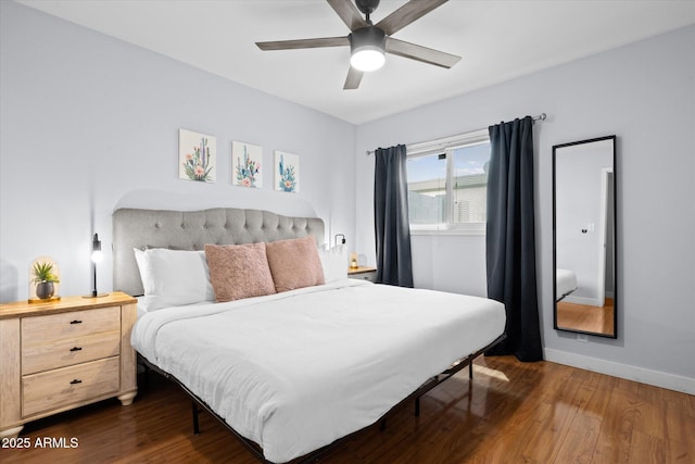 bedroom with ceiling fan and dark wood-type flooring