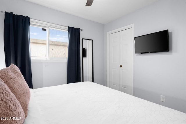 bedroom featuring ceiling fan and a closet