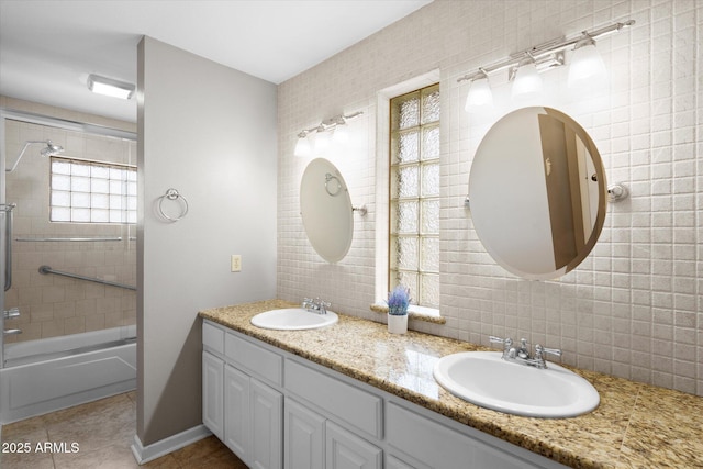 bathroom with decorative backsplash, tile walls, washtub / shower combination, and tile patterned flooring