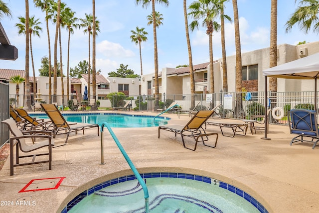 view of pool featuring a patio and a community hot tub