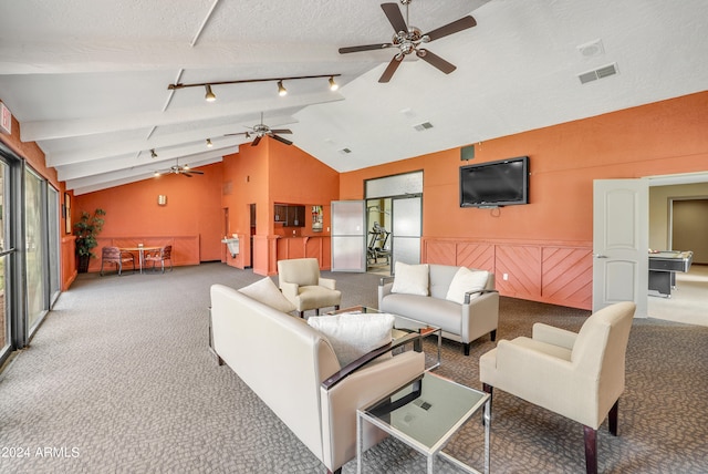 living room featuring track lighting, carpet floors, ceiling fan, vaulted ceiling, and a textured ceiling