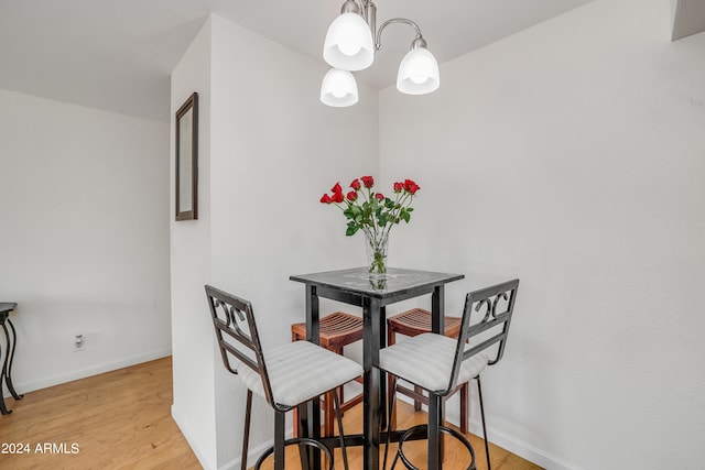 dining room with an inviting chandelier and light hardwood / wood-style flooring