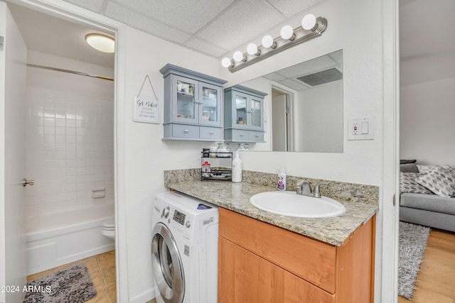 full bathroom with vanity, shower / tub combination, washer / dryer, a paneled ceiling, and toilet