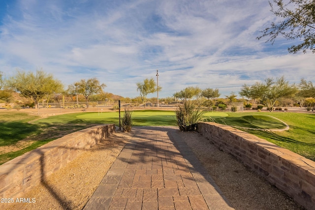 surrounding community featuring a yard and golf course view