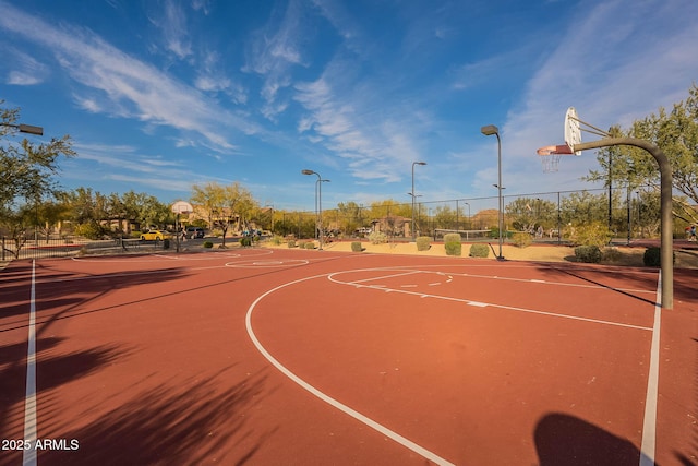 view of basketball court with community basketball court and fence