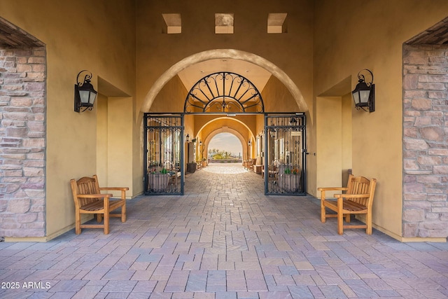 doorway to property with stucco siding and brick siding