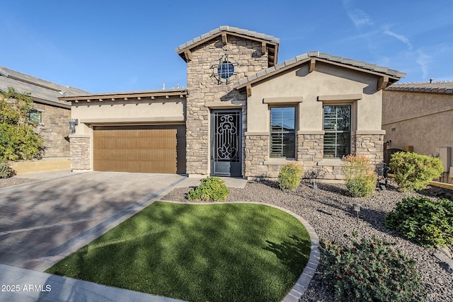 view of front of home with an attached garage, stone siding, driveway, and stucco siding