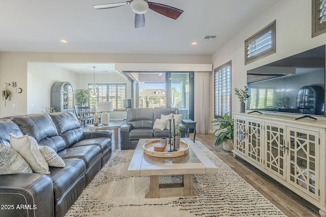 living area with a ceiling fan, visible vents, wood finished floors, and recessed lighting