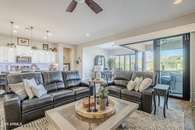 living area with light wood finished floors, ceiling fan, visible vents, and recessed lighting