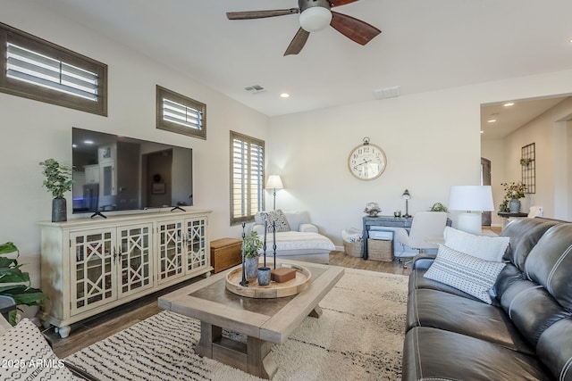 living area with a ceiling fan, visible vents, wood finished floors, and recessed lighting