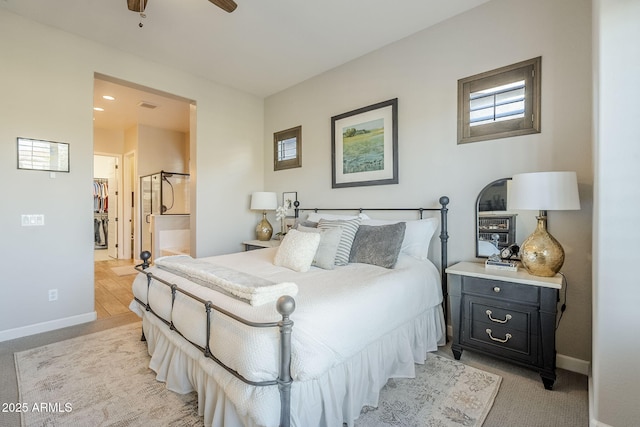 bedroom featuring visible vents, ensuite bath, and baseboards