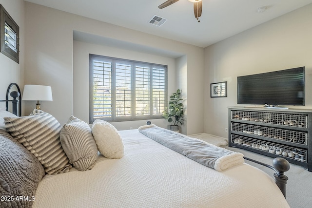 carpeted bedroom with ceiling fan and visible vents