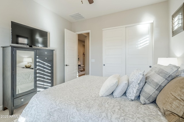 bedroom with ceiling fan, a closet, carpet flooring, and visible vents