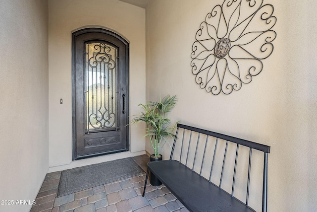 view of exterior entry featuring stucco siding