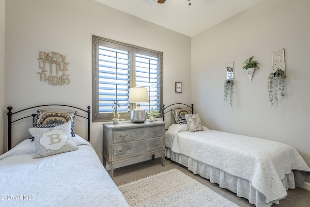 bedroom with a ceiling fan and light colored carpet