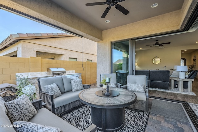 view of patio with a ceiling fan, fence, an outdoor living space, and grilling area