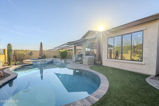 view of pool featuring a fenced backyard, a pool with connected hot tub, and a patio