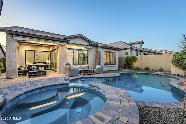 back of house with stucco siding, fence, outdoor lounge area, and a patio