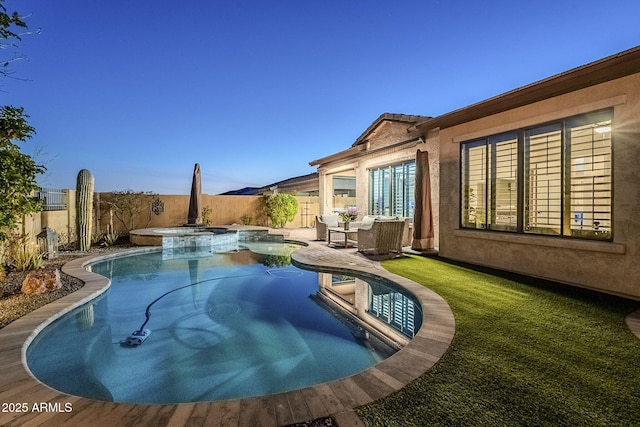 view of pool featuring a fenced backyard, a pool with connected hot tub, and a patio