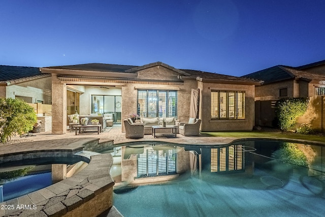 back of house with a patio area, a pool with connected hot tub, fence, and outdoor lounge area