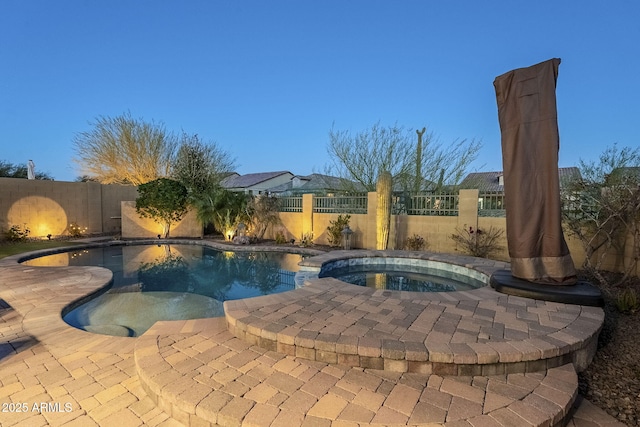 view of pool featuring a patio area, a fenced backyard, a fenced in pool, and an in ground hot tub