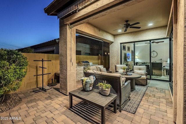 view of patio featuring a ceiling fan, fence, grilling area, and an outdoor kitchen