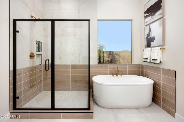 bathroom with shower with separate bathtub and tile walls