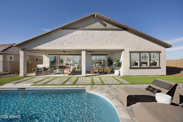 back of house featuring ceiling fan, a patio, and an outdoor hangout area