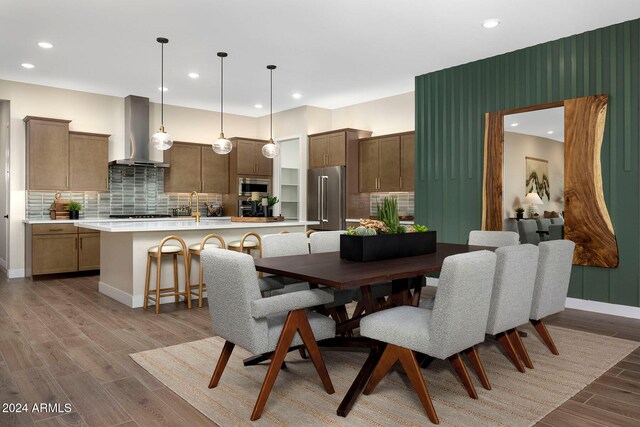 dining room featuring sink and light wood-type flooring