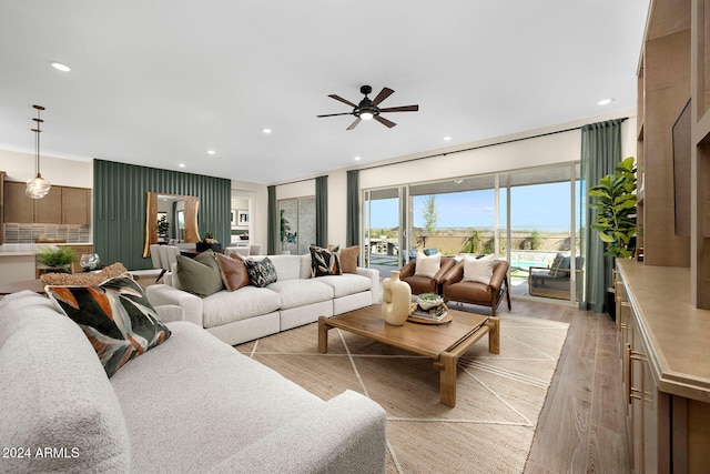 living room with light hardwood / wood-style floors and ceiling fan