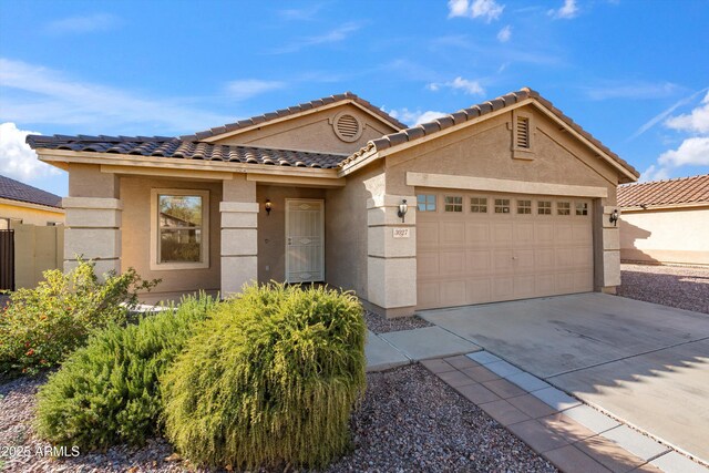 ranch-style house with driveway, stucco siding, a garage, and a tile roof