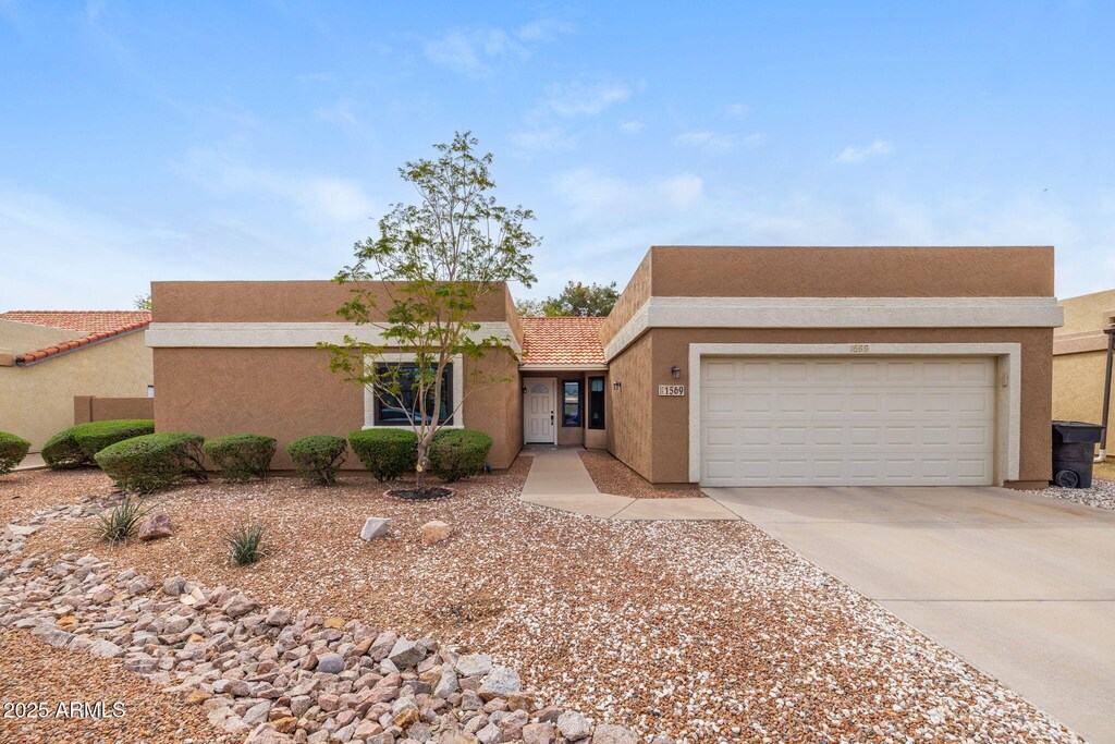 1569 E Whitten St, Chandler, AZ 85225 - view of front of property featuring stucco siding, an attached garage, a tiled roof, and concrete driveway
