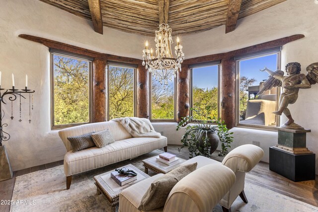 sunroom / solarium with beamed ceiling and an inviting chandelier