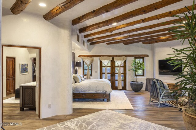 bedroom featuring french doors, beamed ceiling, wood finished floors, and recessed lighting