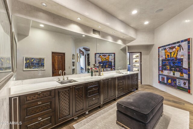 full bath with double vanity, a sink, visible vents, and recessed lighting