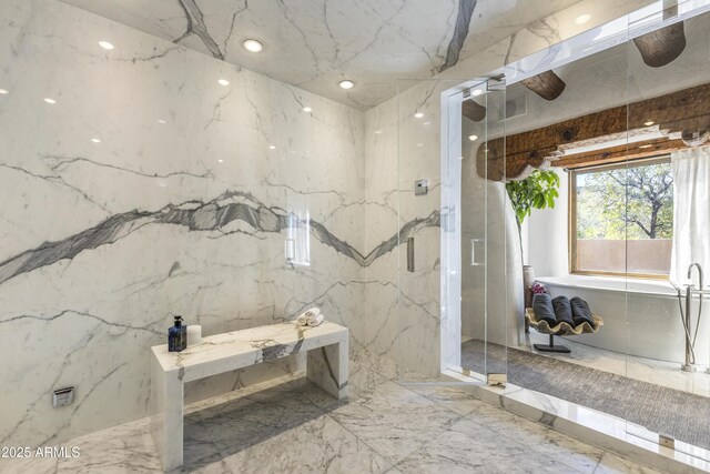 bathroom featuring marble finish floor, stone wall, and a marble finish shower